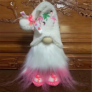 Detailed view of plush gnome doll with flamingo hat embroidery and pink gradient beard