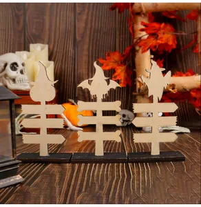 Close-up of Halloween wooden signs showing natural wood grain and laser-cut edges.