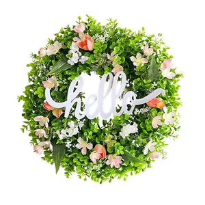 Artificial spring eucalyptus wreath featuring pink flowers and a white Hello sign.