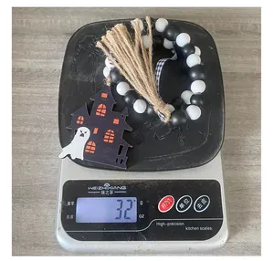 Weight measurement showing 32g for the Halloween wooden bead garland with ghost pendant