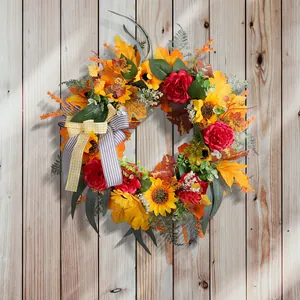 Thanksgiving harvest wreath with autumn maple leaves, sunflowers, and a decorative bow