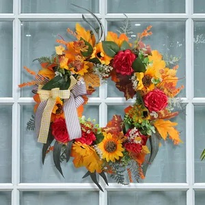 Autumn Thanksgiving wreath with sunflowers, maple leaves, and a decorative striped bow