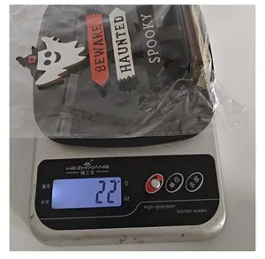 Weight measurement of Halloween ghost wooden sign decor showing 22 grams on scale