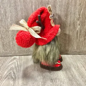 Close-up side profile of a Christmas gnome doll with reindeer hat and faux fur details