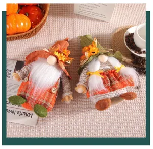 Detailed view of two Thanksgiving sunflower gnomes featuring autumn leaves and plaid clothes