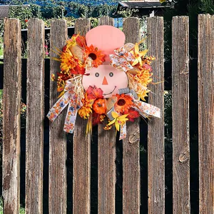 Decorative autumn harvest scarecrow wooden wreath with sunflowers on a rustic wooden fence