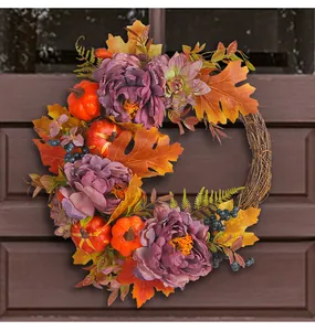 Detailed view of autumn harvest wreath featuring purple peonies and vibrant pumpkins