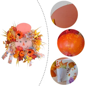 Handcrafted autumn harvest wreath with scarecrow face, pumpkins and vibrant sunflowers