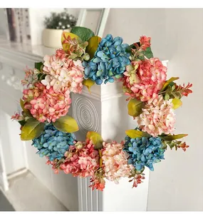 Detailed view of a vibrant blue and pink hydrangea floral wreath for home decoration.
