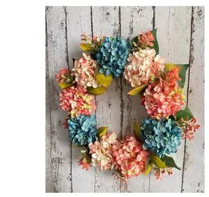 Rustic blue and pink hydrangea artificial wreath on a weathered wooden wall background