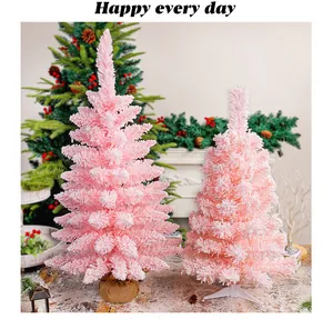 Due alberi di Natale artificiali rosa con effetto neve e basi in iuta e plastica
