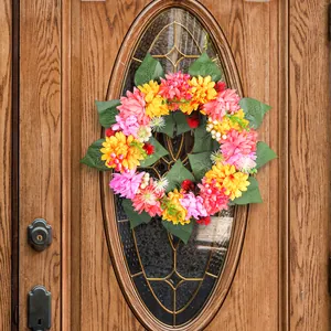 Colorful autumn chrysanthemum flower wreath for Thanksgiving hanging on a wooden door