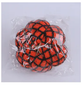 Detailansicht eines handgestrickten orange-schwarzen Kürbis-Ornaments in Kunststoffverpackung.