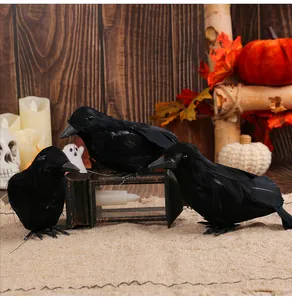 Realistic black feathered crows displayed on a festive Halloween tabletop setting