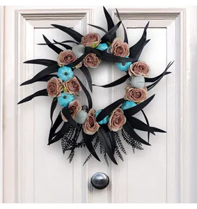 Halloween door wreath decoration featuring blue pumpkins, skulls, and roses on black foliage