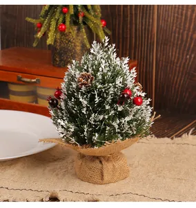 Rustic mini Christmas tree with red berries and burlap base for desktop decoration
