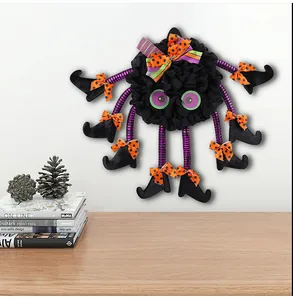Handmade Halloween spider door wreath with colorful striped legs and witch shoes decor