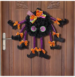 Detailed view of Halloween spider door hanger featuring purple striped legs and bows