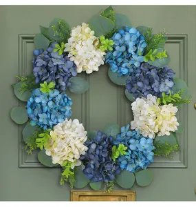 Detailed view of blue and white hydrangea wreath with eucalyptus leaves on green door