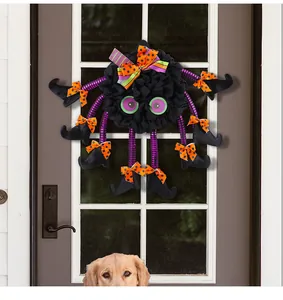 Whimsical black Halloween spider wreath with purple striped legs for festive door decor