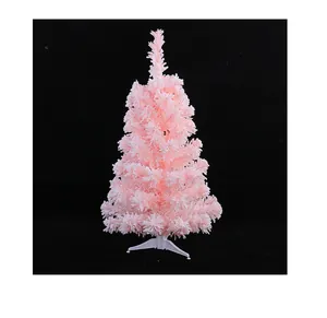 Dettaglio dell'albero di Natale artificiale rosa con effetto neve floccata bianca