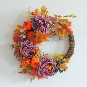 Fall harvest wreath with purple peonies, pumpkins and maple leaves for home decor