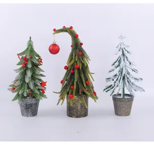 Three unique artificial mini Christmas trees with red berries and snow for desktop decor