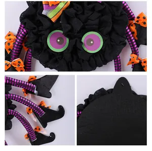 Detailed macro view of Halloween spider door hanging wreath with striped legs and bows