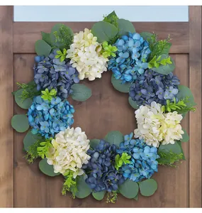 Detailed view of blue and white hydrangea wreath with eucalyptus on a wooden door