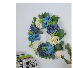 Detail view of blue and white artificial hydrangea wreath hanging on an interior wall
