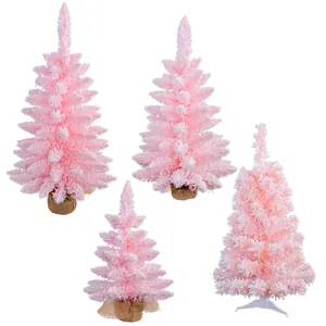 Set di quattro alberi di Natale rosa floccati con effetto neve e basi in juta naturale