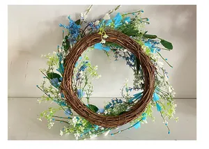 Close-up detail of a blue and white berry grapevine wreath for door hanging.