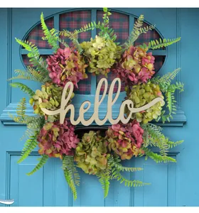 Macro detail of a decorative artificial hydrangea wreath with a wooden hello sign.