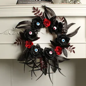 Gothic Halloween wreath with black roses, red accents and creepy eyeballs for decor.