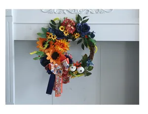 Detailed view of autumn floral wreath featuring blue peonies, sunflowers and mini pumpkins