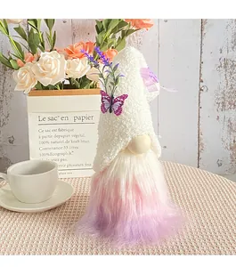 Detailed view of plush gnome with lavender flowers and purple butterfly on white fuzzy hat