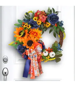Detailed view of a blue sunflower wreath with pumpkins and hydrangeas on a white door.