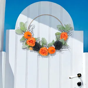 Corona di Halloween con rose arancioni e zucche su anello di metallo per la casa.