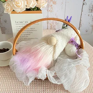 Cute plush gnome doll with purple gradient beard in a decorative basket