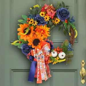 Beautiful autumn floral wreath with blue roses, sunflowers and pumpkins for door