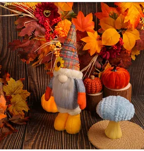 Adorable peluche de gnomo de Acción de Gracias con girasol entre hojas de otoño