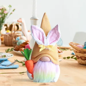 Feestelijke pluchen paaskabouter met konijnenoren en een kleurrijke baard die een wortel vasthoudt