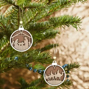 Detailed view of laser-cut wooden nativity scene Christmas tree ornaments hanging