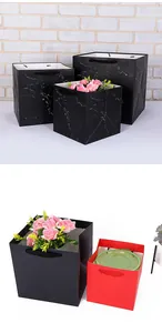Square black marble and red kraft paper gift bags with handles and floral decor