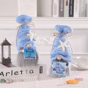 Two ocean-themed handmade knitted gnomes with starfish hats and decorative beach signs