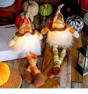 Detail of illuminated autumn harvest gnomes with maple leaf hats and long legs