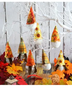 Detail showing hanging harvest gnome ornaments with sunflower and maple leaf patterns