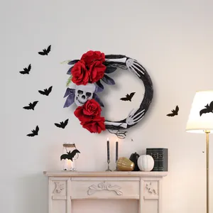 Couronne d'Halloween gothique avec crâne, roses rouges et mains de squelette sur mur