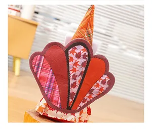 Close-up detail of Thanksgiving turkey gnome doll featuring maple leaf and plaid patterns