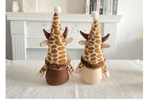 Pair of cute giraffe print faceless gnome dolls for home decor on a rustic white table